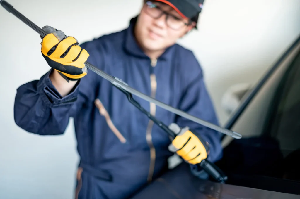 A technician inspecting a windshield wiper