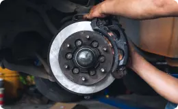 mechanic repairing car brakes