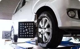 silver car undergoing wheel alignment