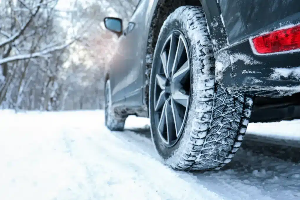 A side of a car driving along a snowy road