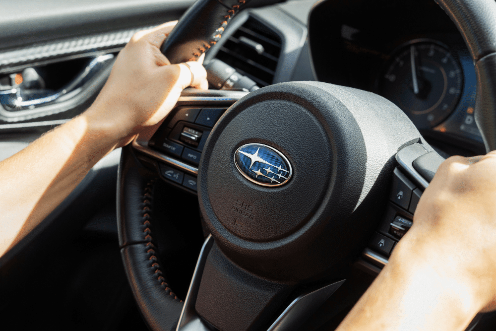 Japanese Auto Repair in Colorado Springs, Auto repair in Colorado Springs, CO at Express Auto Repair & Service. Image of a driver holding the steering wheel of a Subaru.