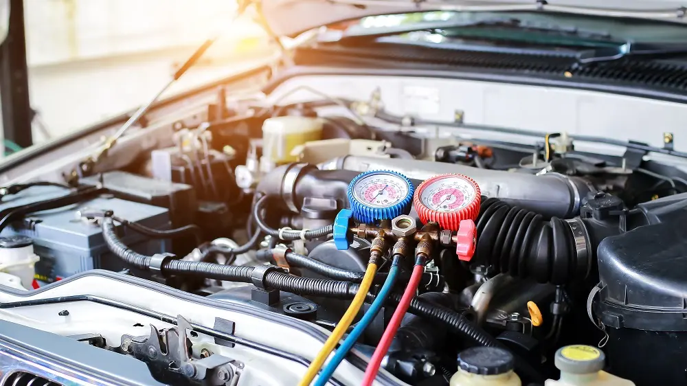 A close-up of a car engine featuring a connected hose, showcasing the intricate components and connections involved.