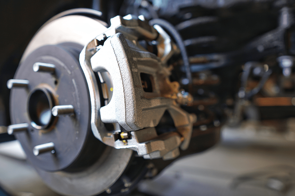 brake repair in Colorado Springs, CO, auto repair in Colorado Springs, CO at Express Auto Repair. Close-up view of a car's brake caliper and rotor.