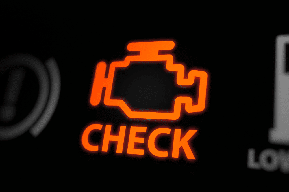 subaru check engine light, auto repair in Colorado Springs, CO at Express Auto Repair. Close-up of an illuminated check engine light on a vehicle dashboard.