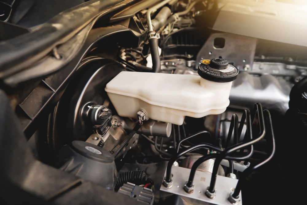 Brake Fluid Replacement, Brake Repair in Colorado Springs CO At Express Auto Repair. Close-up view of vehicle brake fluid reservoir
