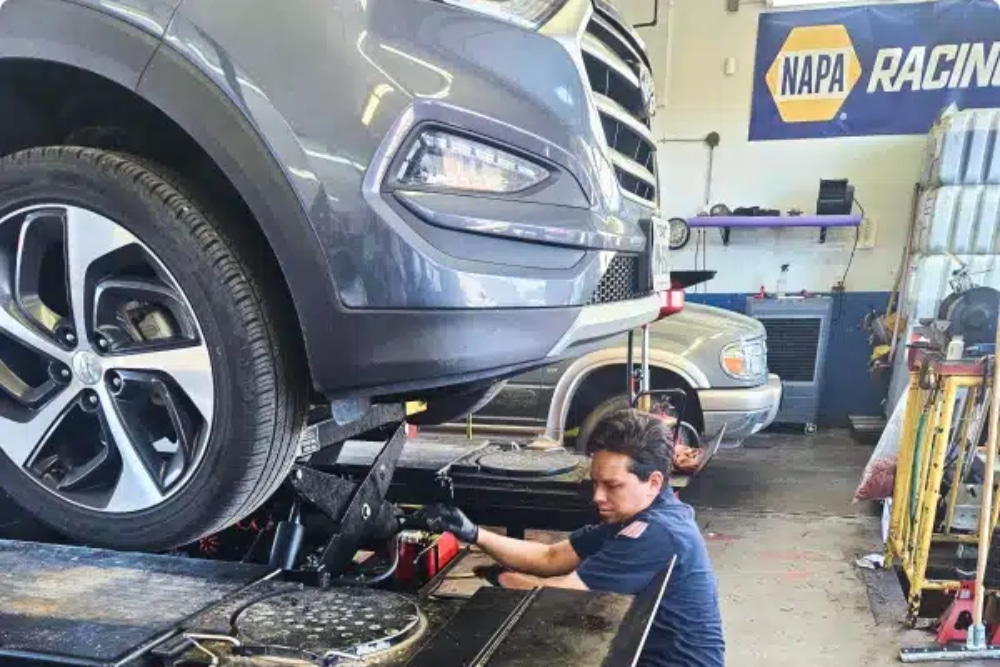 Car Maintenance in Colorado Springs CO At Express Auto Repair. Mechanic performing routine car maintenance in an auto repair shop