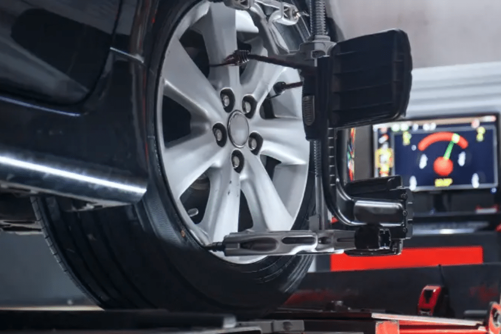 Wheel Alignment in Colorado Springs CO At Express Auto Repair. Image of Vehicle slightly lifted during wheel alignment service at auto repair shop