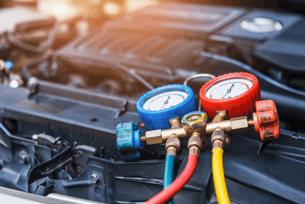 Car a/c recharge in Colorado Springs, CO at Express Auto Repair. Image of professional air conditioning diagnostic gauges connected to a vehicle during A/C system testing and refrigerant performance inspection.