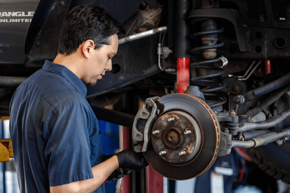 Brake repair, auto repair in Colorado Springs, CO, at Express Auto Repair. Image of a technician inspecting and servicing a vehicle's brake rotor and caliper to restore dependable stopping power, improve braking performance, and keep drivers safe.