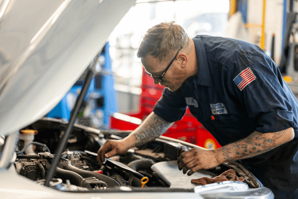 Engine care, auto repair in Colorado Springs, CO at Express Auto Repair. Image of a technician inspecting components under an open hood to support reliable engine performance and vehicle maintenance.